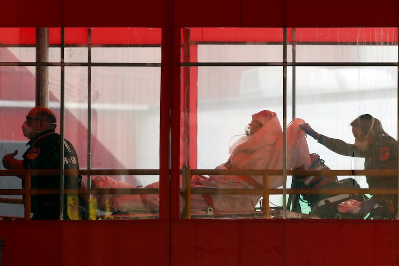 Emergency medical technicians wheel a patient into Elmhurst Hospital Center’s emergency room on Tuesday, April 7, 2020, in the Queens borough in New York, during the current coronavirus outbreak. (AP Photo/Kathy Willens)