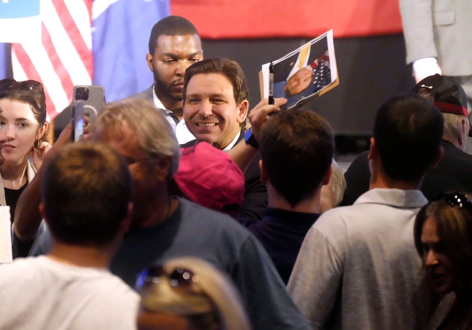 Florida Gov. Ron DeSantis smiles for photos as he signs books following remarks to a crowd at First Baptist North on April 19, 2023, in Spartanburg, S.C.