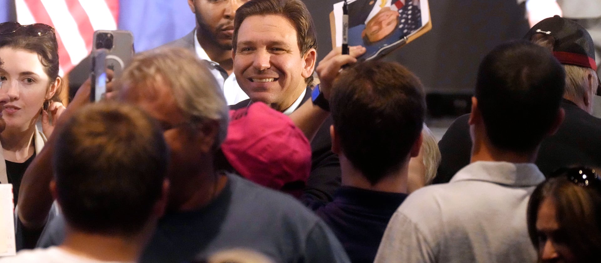 Florida Gov. Ron DeSantis smiles for photos as he signs books following remarks to a crowd at First Baptist North on April 19, 2023, in Spartanburg, S.C.