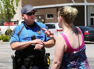 Unified police officer Jeff Fenton talks with Jennica Martinez after witnessing her running down the street yelling at her husband, Caesar Martinez, on Monday, June 3, 2019. Midvale is considering withdrawing from the Unified Police Department based on sa