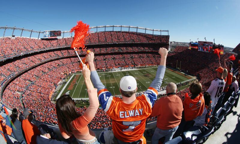 FILE - Denver Broncos fans cheer as the AFC championship NFL football playoff game between the Broncos and the New England Patriots was about to start, Jan. 19, 2014, in Denver. The Walton family has won the bidding to purchase the Broncos in the most expensive deal for a sports franchise anywhere in the world.