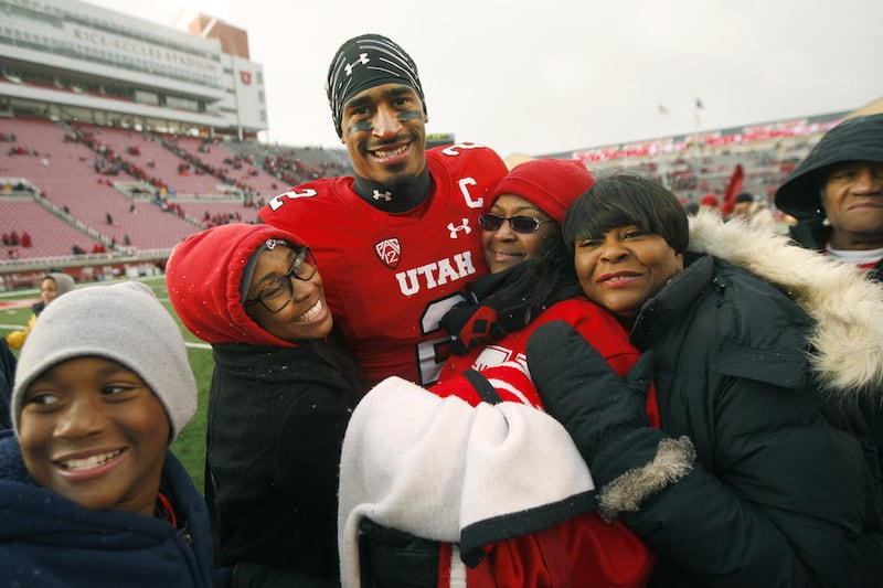 Utah Utes wide receiver Kenneth Scott (2) is surrounded by family after the game as Utah defeated Colorado 20-14 at Rice-Eccles Stadium in Salt Lake City Saturday, Nov. 28, 2015.