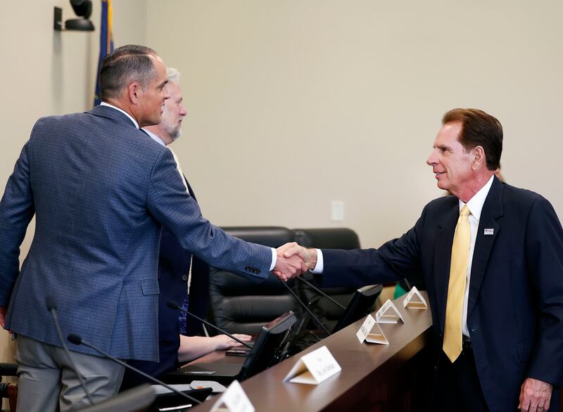 State Sen. Mike McKell shakes hands with Fraser Bullock, CEO of the Salt Lake City-Utah Committee for the Games.