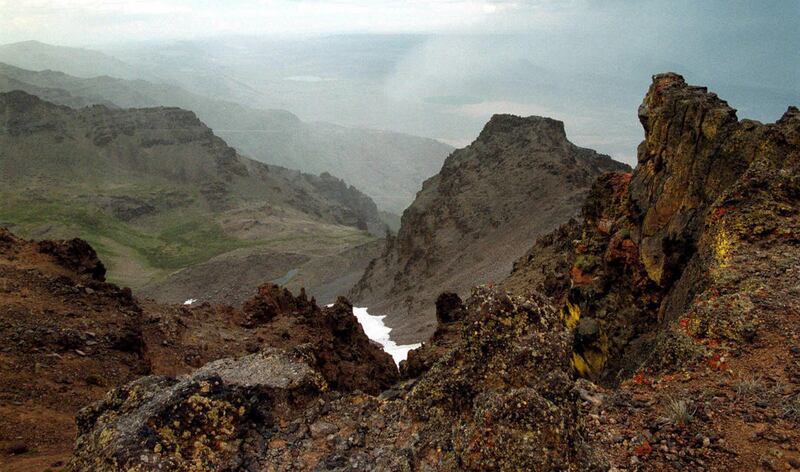 This Aug. 4, 1999 file photo shows a rocky outcrop on Steens Mountain in southeastern Oregon. Skeletal remains found on the mountain have been identified from personal identification items as Dustin Self of Piedmont, Okla., who disappeared in spring 2013