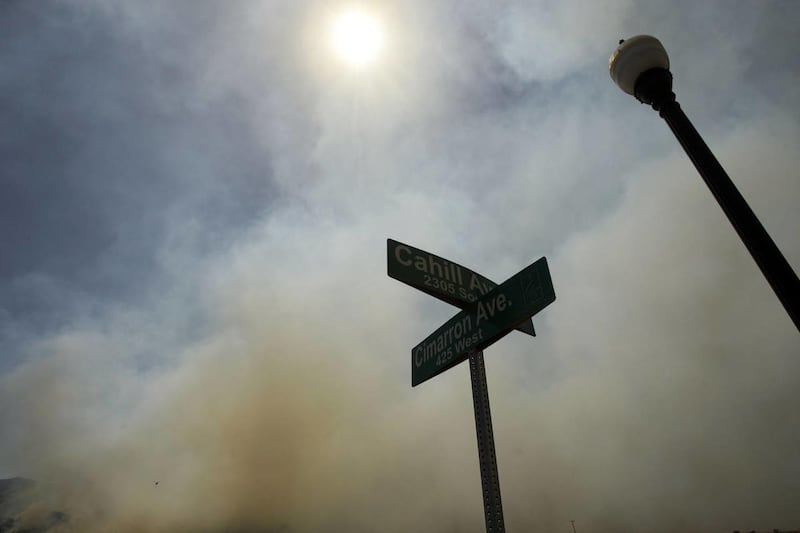 Emergency responders work on a wild land fire that is threatening homes in Saratoga Springs Friday, June 22, 2012.