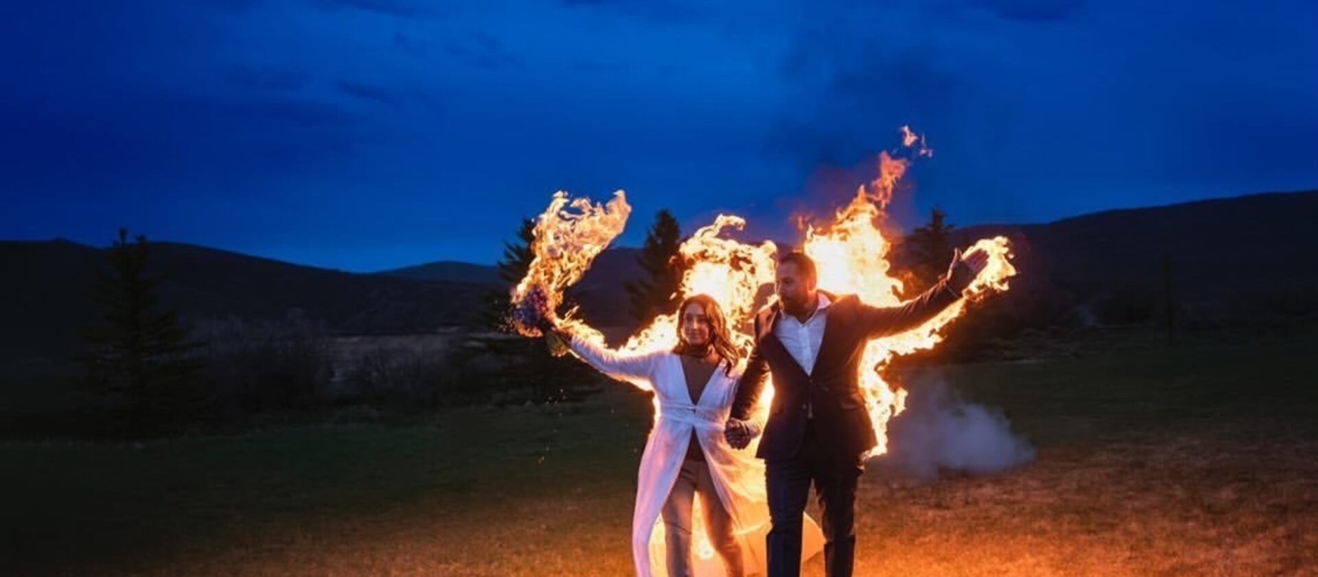 Gabe Jessop and Ambyr Mishelle walk the shores of Jordanelle State Park in flames at their wedding earlier this month.
