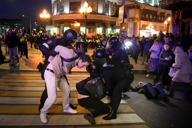 Riot police detain demonstrators during a protest against mobilization in Moscow, Russia.