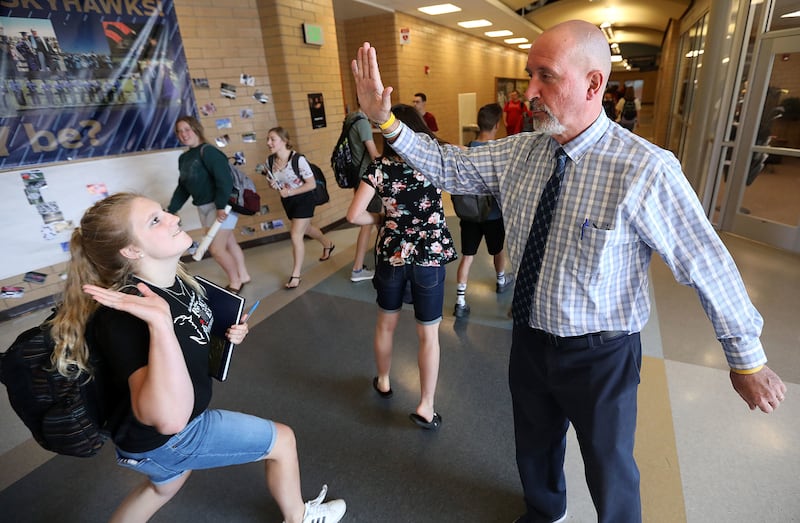 Claire Wride winds up for a high-five with Principal Bart Peery at Salem Hills High School in Salem on Thursday, May 24, 2018.