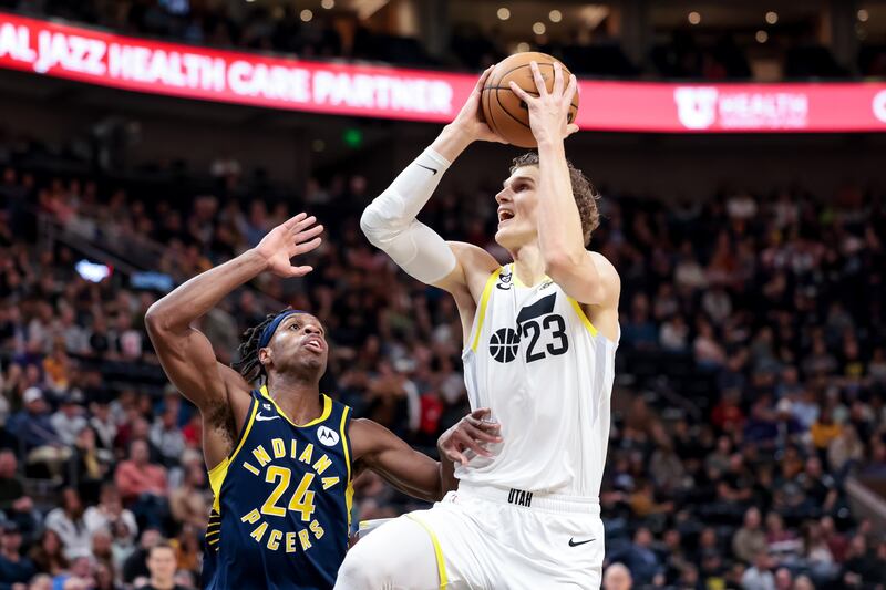 Utah Jazz forward Lauri Markkanen (23) goes to the hoop against Indiana Pacers guard Buddy Hield (24) during a game at Vivint Arena in Salt Lake City on Friday, Dec. 2, 2022.