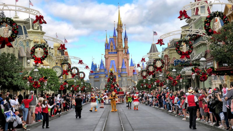 Crowds line Main Street USA, with Cinderella Castle on the horizon, at the Magic Kingdom at Walt Disney World, in Lake Buena Vista, Fla., Monday, Dec. 21, 2020. Disney’s Florida parks are currently operating at 35% capacity due to the Covid-19 pandemic.
