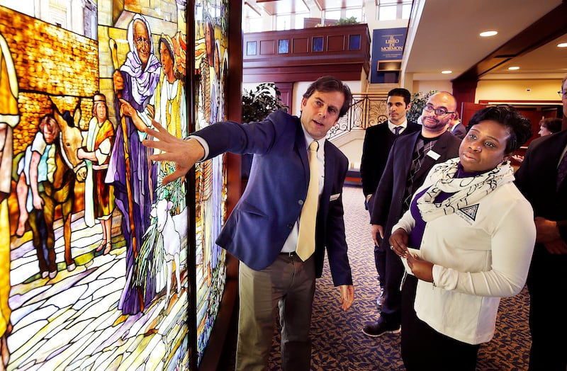 Tom Holdman, left, of Holdman Studios, discusses his company's stained glass work with Pastor Chris Zacharias and his wife, Kim, of the John Wesley A.M.E. Zion Church during a tour of the Rome Italy Temple and the Rome Temple Visitors' Center on Tuesday,