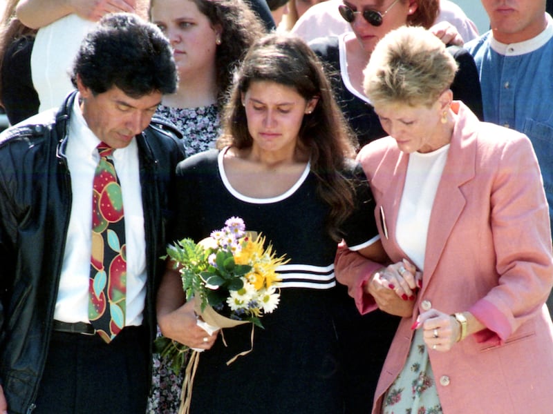 An injured Yvette Rodier is helped down a flight of stairs after the funeral of her friend Zachary Snarr.