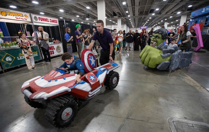 Scott and Crystal Shank push sons Braxden and Jayden in their new, specially built wheelchair costumes during the FanXSalt Lake Comic Convention at the Salt Palace Convention Center in Salt Lake City on Friday, Sept. 7, 2018. Magic Wheelchair, a nonprofit
