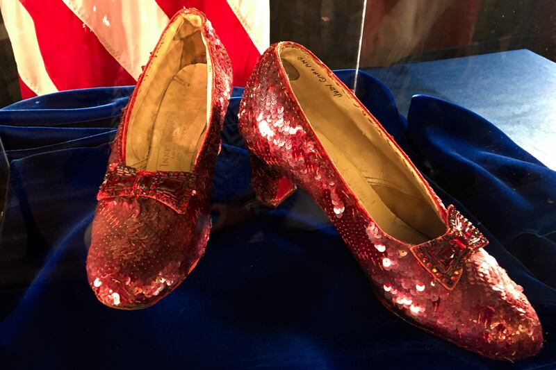 A pair of ruby slippers once worn by actress Judy Garland in the “The Wizard of Oz” sit on display on Sept. 4, 2018.