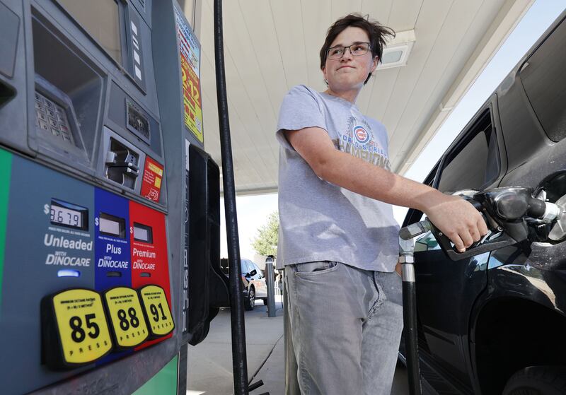 Robert Ketchum fills his car with gasoline for his commute to school in Cottonwood Heights.