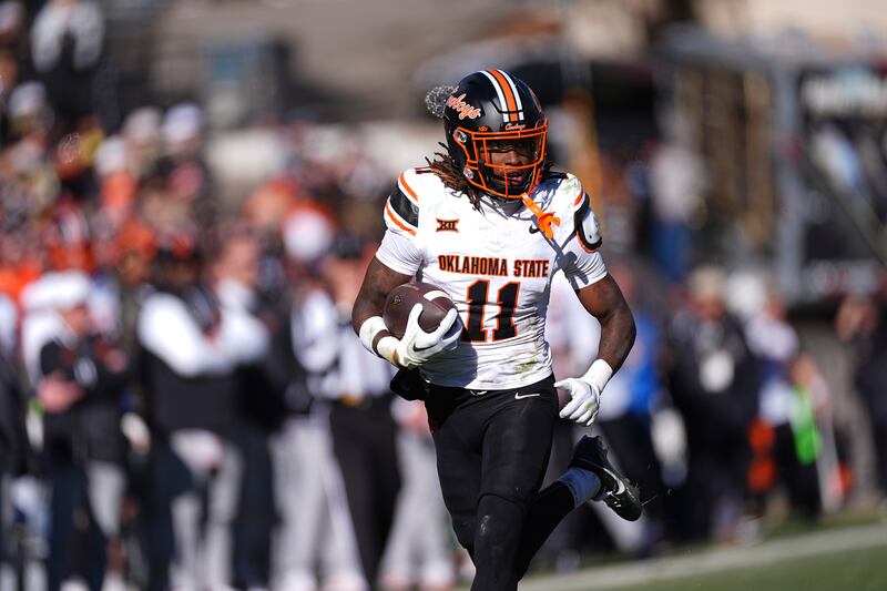 Oklahoma State safety Dylan Smith returns an interception during game against Colorado Friday, Nov. 29, 2024, in Boulder, Colo.