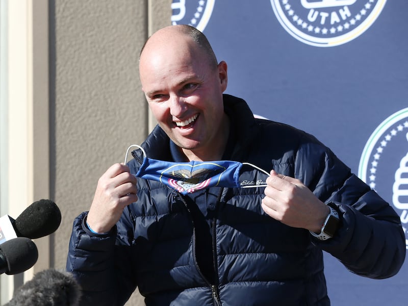 Gov.-elect Spencer Cox takes off his mask as he talks to members the media at the Utah Food Bank in this Jan. 2 photo from St. George, Utah. Thursday Cox announced that the age limit to get vaccinated will drop from 70 and older to 65 and older beginning March 1.