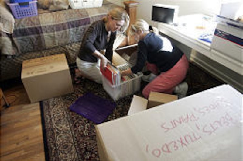 Wanda Schmitt, left, and her stepmother, Ann Nichols, box up personal belongings of Jeff Nichols, who has been missing since June 8.