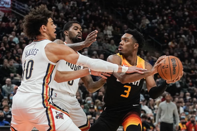 Utah Jazz guard Trent Forrest looks to pass the ball as New Orleans Pelicans’ Jaxson Hayes and Naji Marshall reach to block.