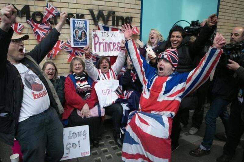 Royal fans and well wishers react after Kensington Palace announced that Kate, the Duchess of Cambridge, had given birth to a girl, outside the Lindo Wing of St. Mary's Hospital, London, Saturday, May 2, 2015. Kensington Palace said in a brief statement t