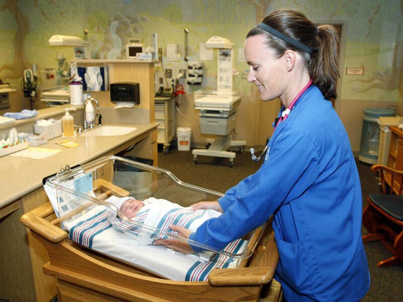 Nurse Angie Hagen tends to a new born baby boy in the nursery at Denver Health medical facility in Denver on Thursday, June 23, 2011. Colorado will end coverage for routine circumcisions under Medicaid next month, adding to what's become a national debate