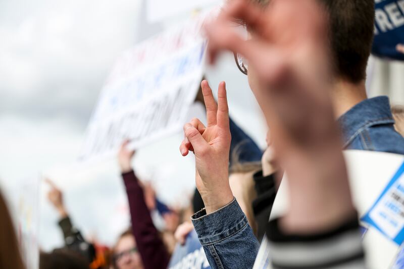 FILE - Protesters flash peace signs during the "March for Our Lives" at the Capitol in Salt Lake City on Saturday, March 24, 2018.