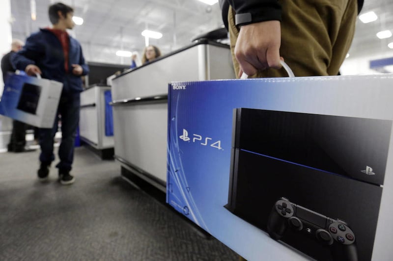 A man holds a Sony PlayStation 4 after he purchased it at the Lincoln Park Best Buy store in Chicago in this Friday, Nov. 15, 2013, file photo. The PlayStation 4 was one of the most-sold items at Walmart this past Black Friday.