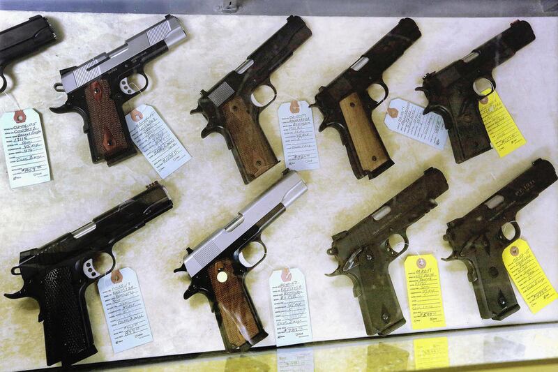 In this July 10, 2013 file photo, semi-automatic handguns are seen display for purchase at Capitol City Arms Supply in Springfield, Ill. On Sunday, Jan. 5, 2014, Illinois residents for the first time can apply for permits to carry concealed weapons. For n