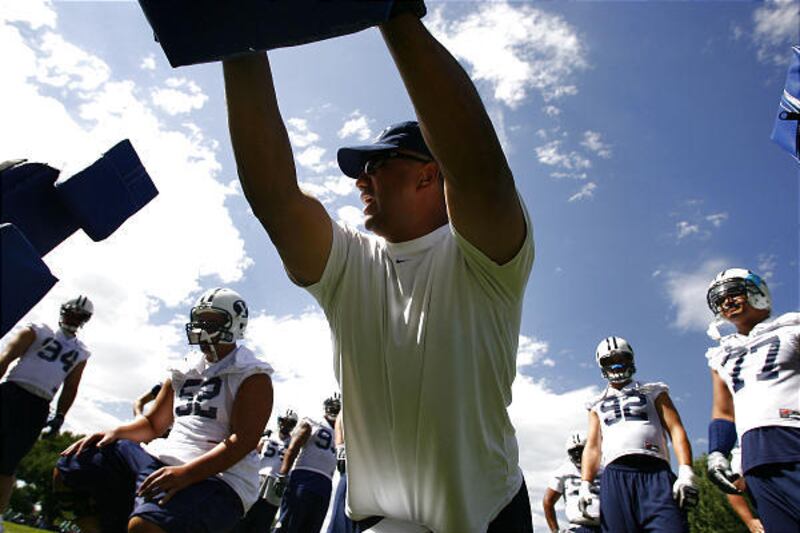 Steve Kaufusi demonstrates how to perform a drill at a BYU practice. Kaufusi had a big influence in getting his family in football.