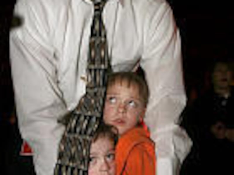 Jason Watson comforts his children Rylie, left, and Emmalie after a gunman opened fire at Trolley Square.