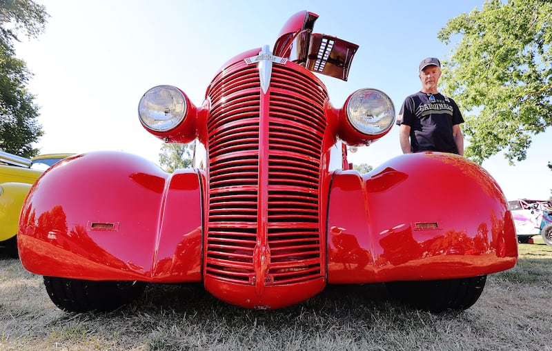 Regan Swain stands near his 1938 Chevy Coupe during the “Rumble in the Park” car show at Pioneer Park in Salt Lake City.