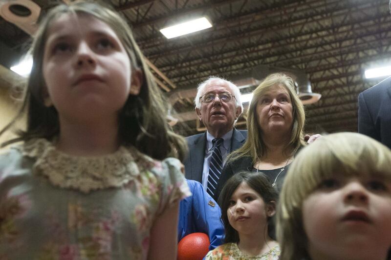 Democratic presidential candidate Sen. Bernie Sanders, I-Vt., center left, and his wife Jane, center right, watch the results of the New Hampshire primary during a watch party at Concord High School, Tuesday, Feb. 9, 2016, in Concord, N.H.