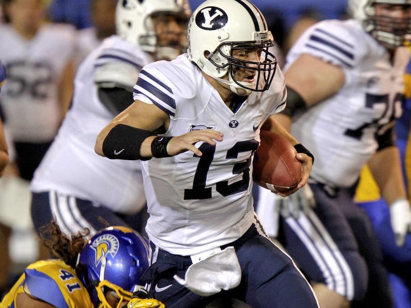Brigham Young quarterback Riley Nelson (13) breaks a tackle by San Jose State defensive end David Tuitupou (41) in the first quarter of an NCAA college football game in San Jose, Calif., Saturday, Nov. 17, 2012.