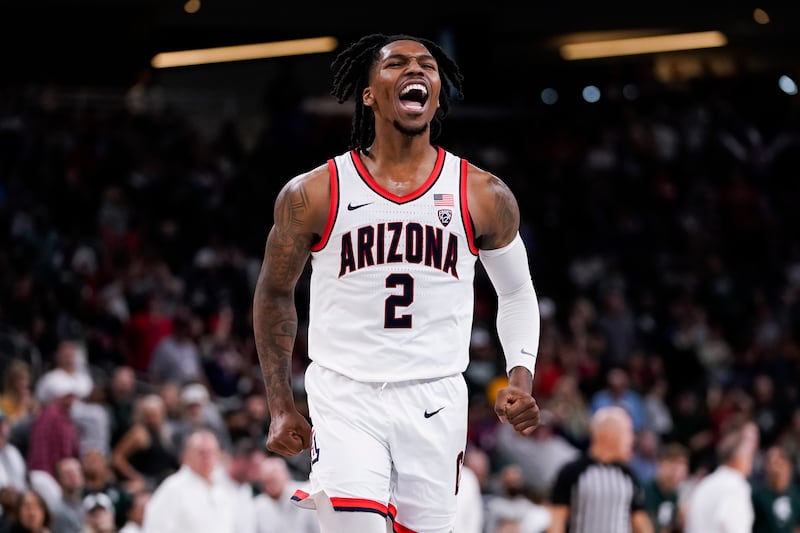Arizona guard Caleb Love reacts after making a buzzer-beater 3-point basket to end the first half a game against Michigan State.