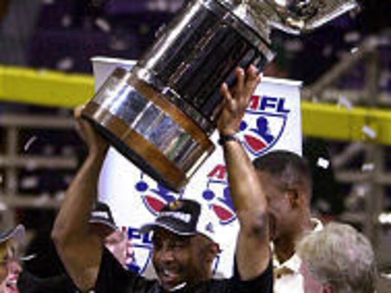 San Jose SaberCats coach Darren Arbet lifts the James F. Foster ArenaBowl trophy above his head after Sunday's victory in Phoenix.