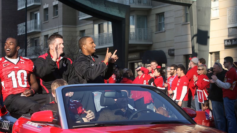 Utah linebacker Stevenson Sylvester (10), Utah head coach Kyle Whittingham and Utah quarterback Brian Johnson (3) ride down State Street Friday, Jan. 16, 2009 in the parade Salt Lake City threw to celebrate Utes defeat over Alabama 31-17 in the 2009 Allst