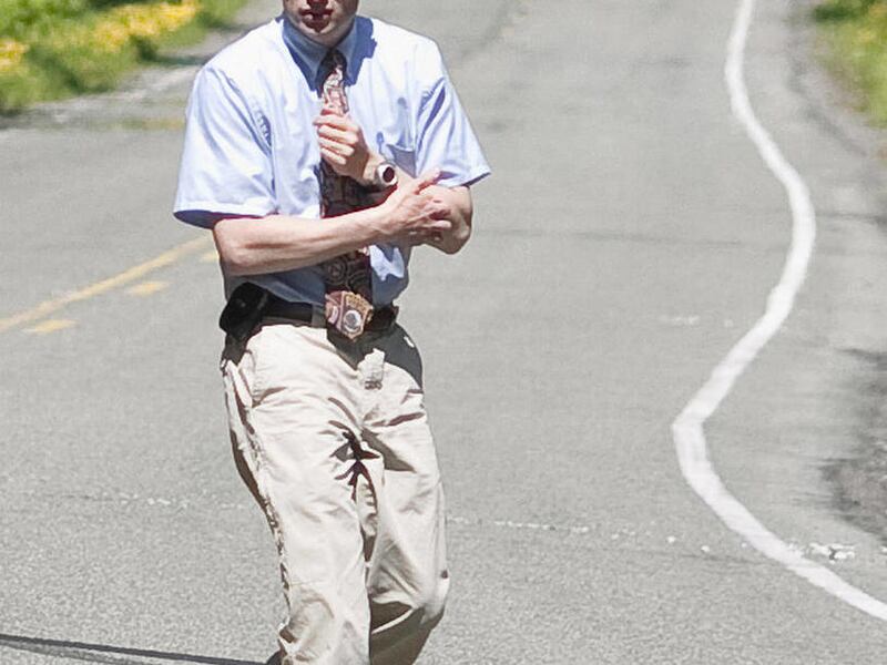In this 2009 photo, Troy Wilson, then a lieutenant with the Juneau Police Department, investigates an accident that took the life of Taylor White, in Juneau, Alaska. Wilson was arrested Sunday, April 8, 2012 after firing 75 shots at police officers and th