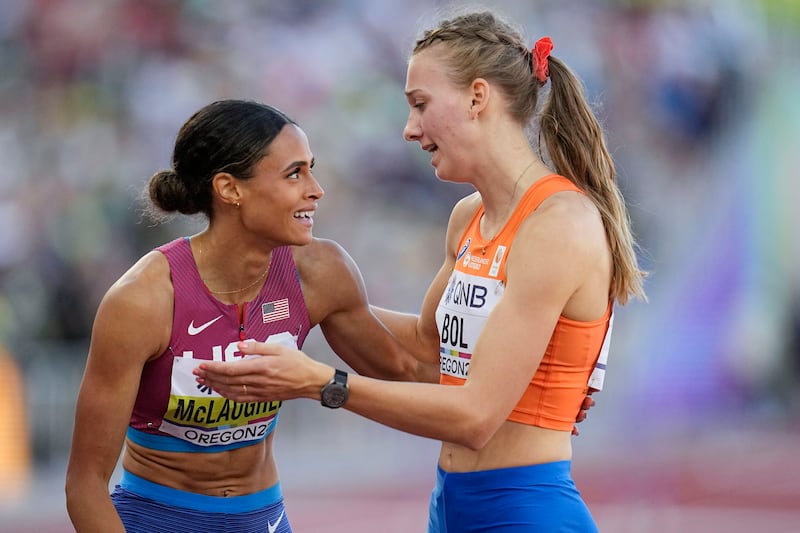 Gold medalist Sydney McLaughlin, of the United States, left, speaks with silver medalist Femke Bol, of the Netherlands, after the final of the women's 400-meter hurdles at the World Athletics Championships on Friday, July 22, 2022, in Eugene, Ore.