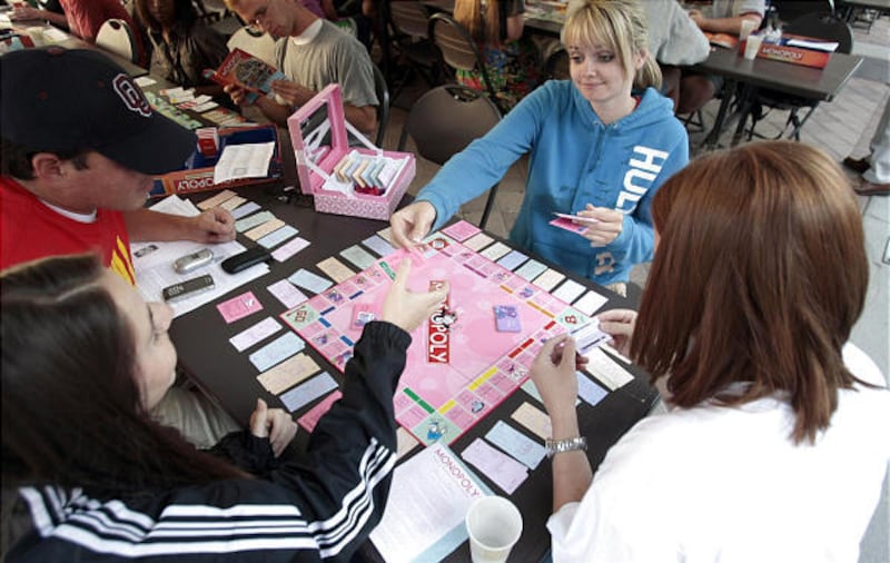 Matt Ramone, left, Burgandy Flammer, Elizabeth Jenkins, top, and Natalie Mitts join record-setting Monopoly game at BYU Wednesday.