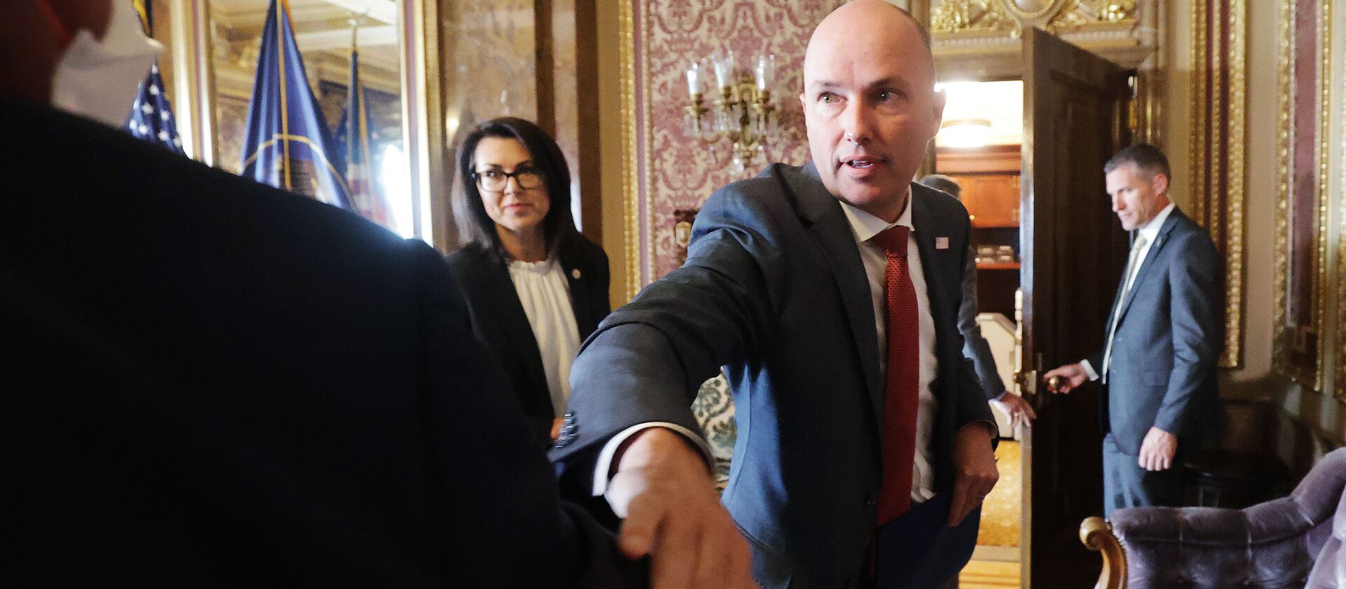 Gov. Spencer Cox elbow-bumps Marc Harrison, CEO of Intermountain Healthcare, after a COVID-19 briefing in Salt Lake City.