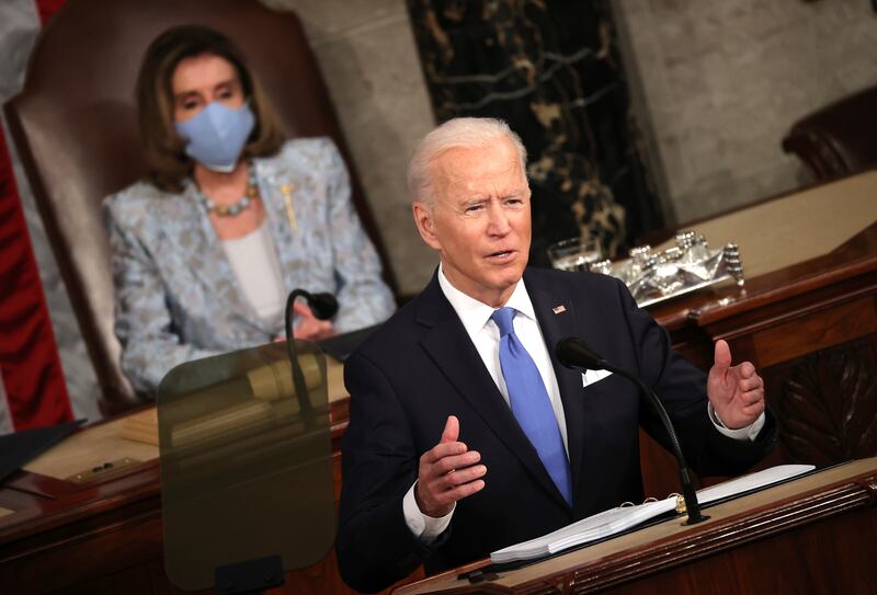 President Joe Biden addresses a joint session of Congress at the U.S. Capitol in Washington, as House Speaker Nancy Pelosi of Calif., watch.