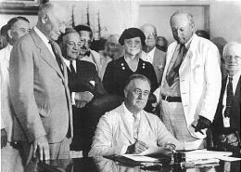 President Roosevelt signs Social Security Act on Aug. 14, 1935.