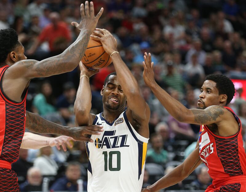 Utah Jazz guard Alec Burks (10) drives to the basket with Perth Wildcats guards Terrico White (23) and Bryce Cotton (11) hounding him as the Utah Jazz and the Perth Wildcats play in an exhibition basketball game at Vivint Smart Home Arena in Salt Lake Cit