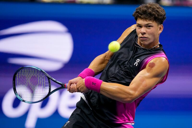 Ben Shelton returns a shot to Frances Tiafoe during the quarterfinals of the U.S. Open tennis championships in New York.