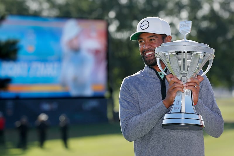 Tony Finau holds up the trophy final round after winning the Houston Open golf tournament Sunday, Nov. 13, 2022, in Houston.