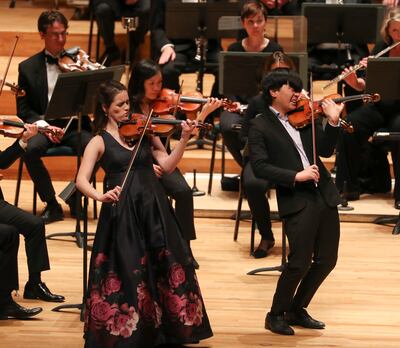 Natalie Boberg and Adrian Wu play the violin with the Utah Symphony during the 59th annual Salute to Youth concert, an event where young musicians perform classical masterpieces as soloists, at Abravanel Hall in Salt Lake City on Tuesday, Sept. 11, 2018.