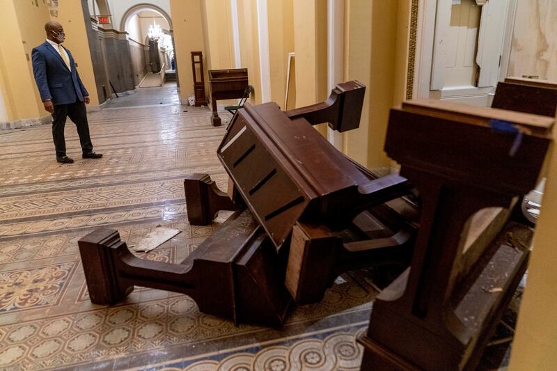 Sen. Tim Scott, R-S.C., stops to look at damage in the early morning hours of Thursday, Jan. 7, 2021, after protesters stormed the Capitol in Washington, on Wednesday.