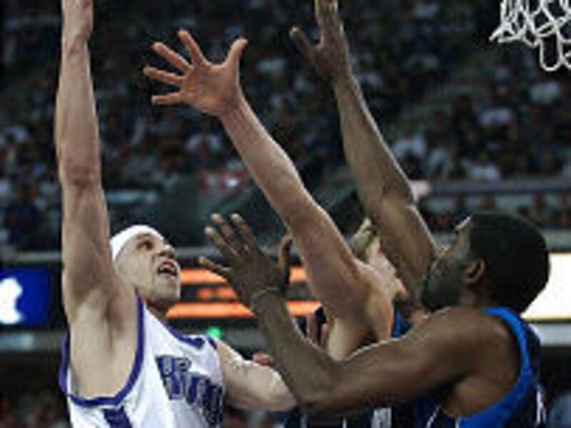 Sacramento Kings' Mike Bibby, left, goes up against Dallas Mavericks' Dirk Nowitzki, center, and Michael Finley during Thursday's Game 5.