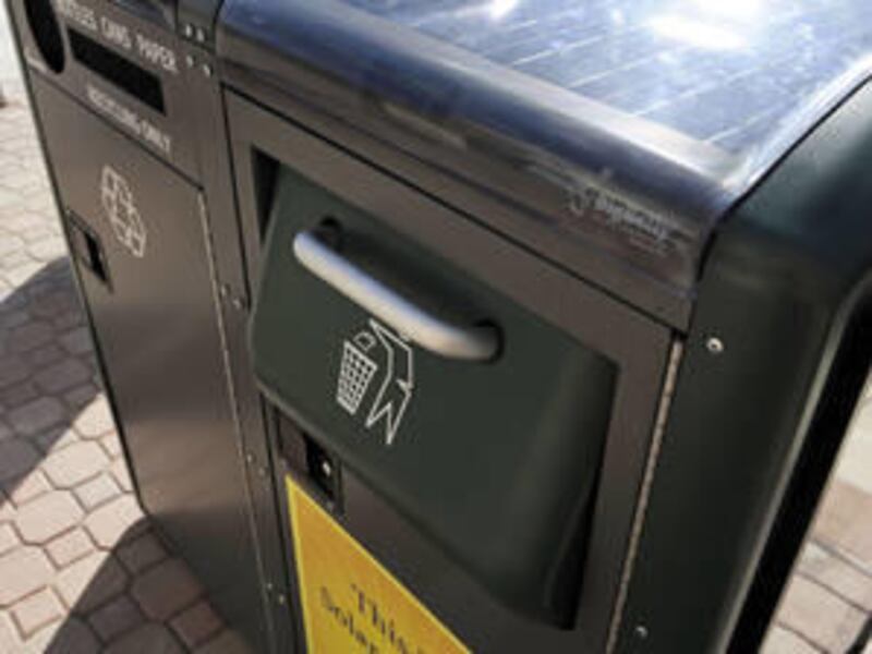A solar-powered trash compactor sits on a sidewalk at The Alaire, in Rockville, Md., Friday, Oct. 1, 2010.