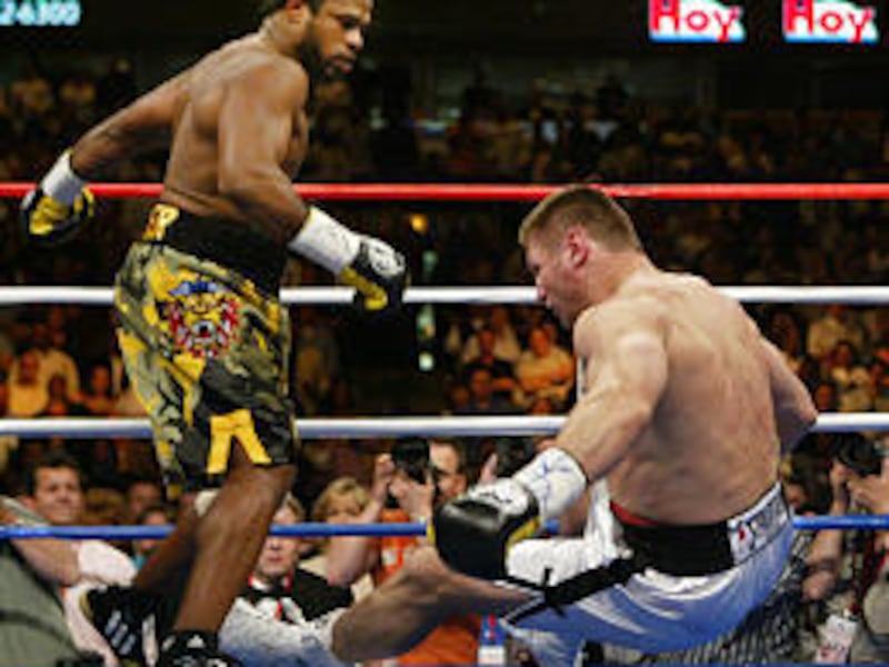 Lemon Brewster knocks Andrew Golota down for the third time in the first round.